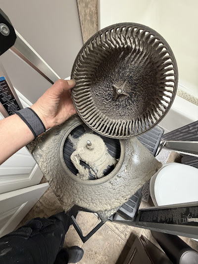Heavily soiled bathroom exhaust fan blower wheel removed for cleaning
